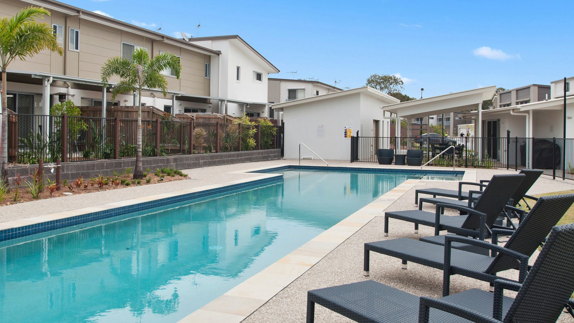 loungers near swimming pool